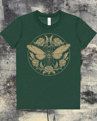 A green kids t-shirt with an illustration of a cicada with florals printed in a gold toned tan ink. 