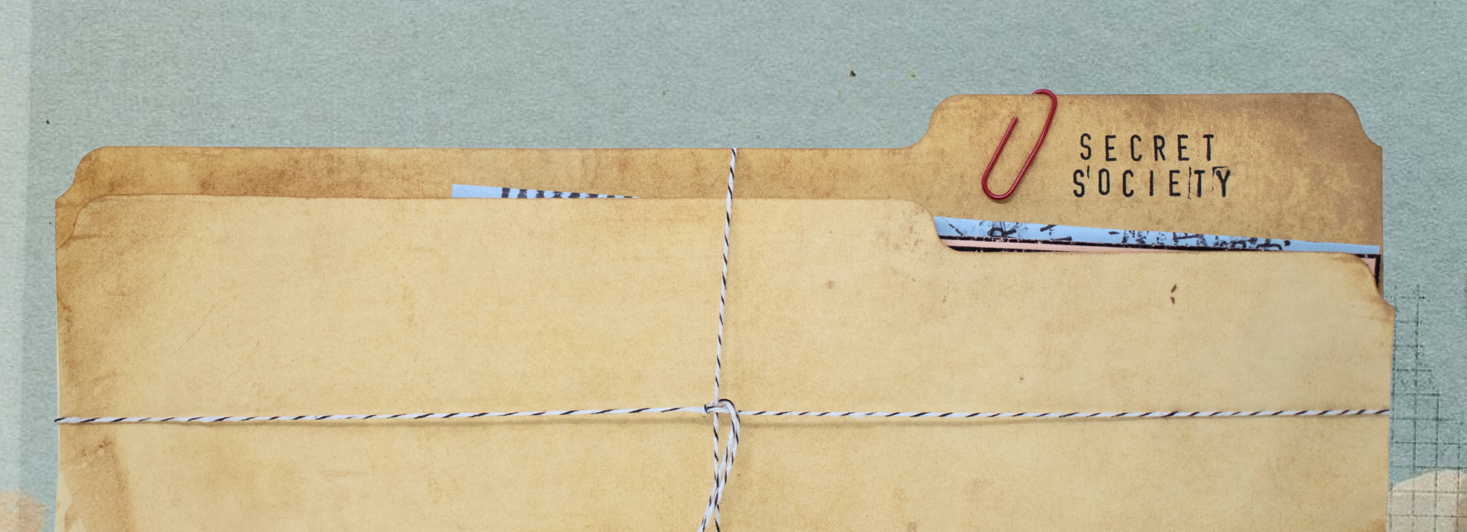 weathered file folder with paper clips and twine holding contents together