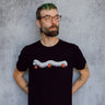 A model wearing a black t-shirt with a hand drawn illustration of a millipede in a ghost costume carrying jack'o lantern candy pails. 