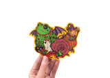 A hand holding a sticker featuring various animals trick or treating in retro style costumes for halloween. 