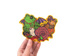 A hand holding a sticker featuring various animals trick or treating in retro style costumes for halloween. 